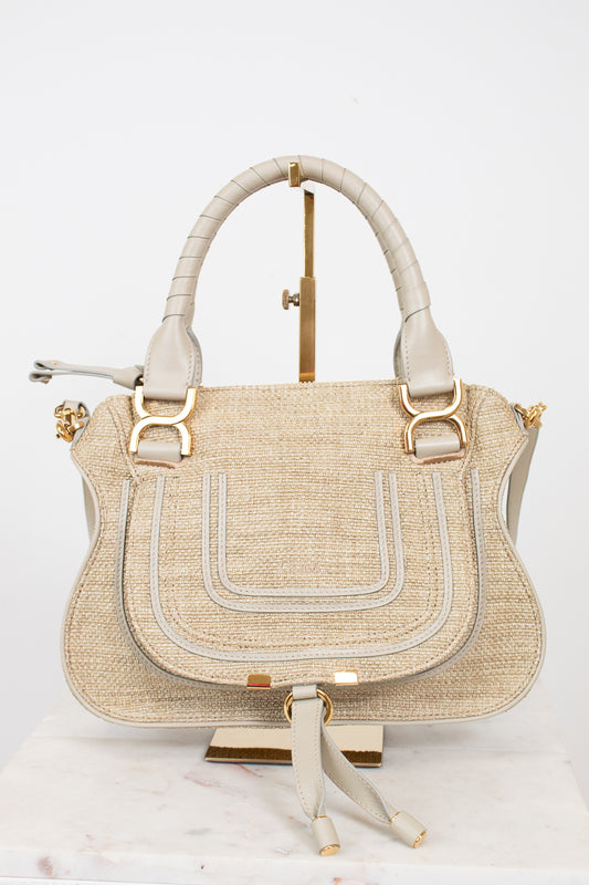 Beige handbag with gold accents on a white background