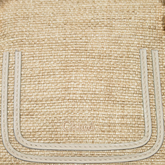 Close-up of a woven handbag with visible branding