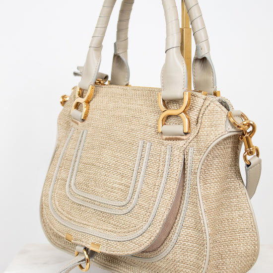 Beige handbag with gold accents on a white background