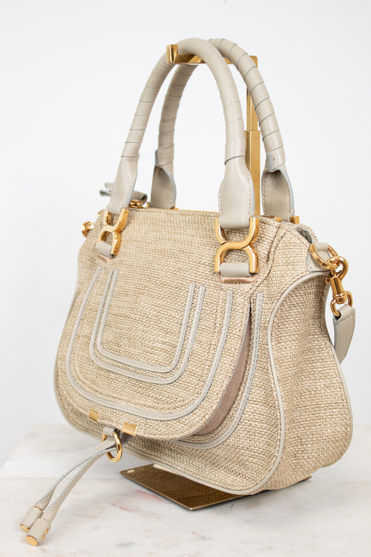 Beige handbag with gold accents on a white background