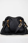 Black handbag with gold hardware on a white background