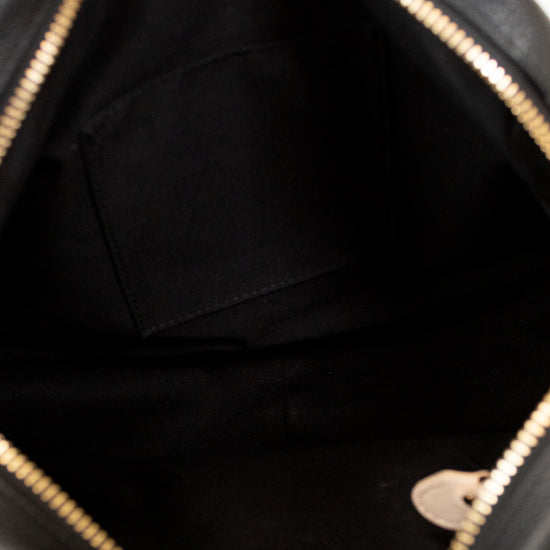 Close-up of a black handbag with gold accents
