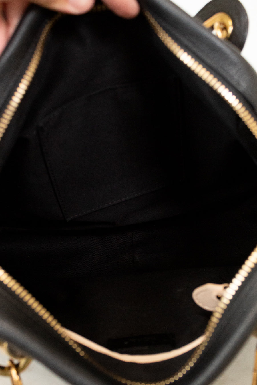 Close-up of a black handbag with gold accents