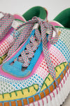 Colorful woven sneakers with patterned laces on a white background