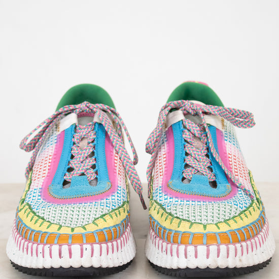 Colorful crochet sneakers on a white background