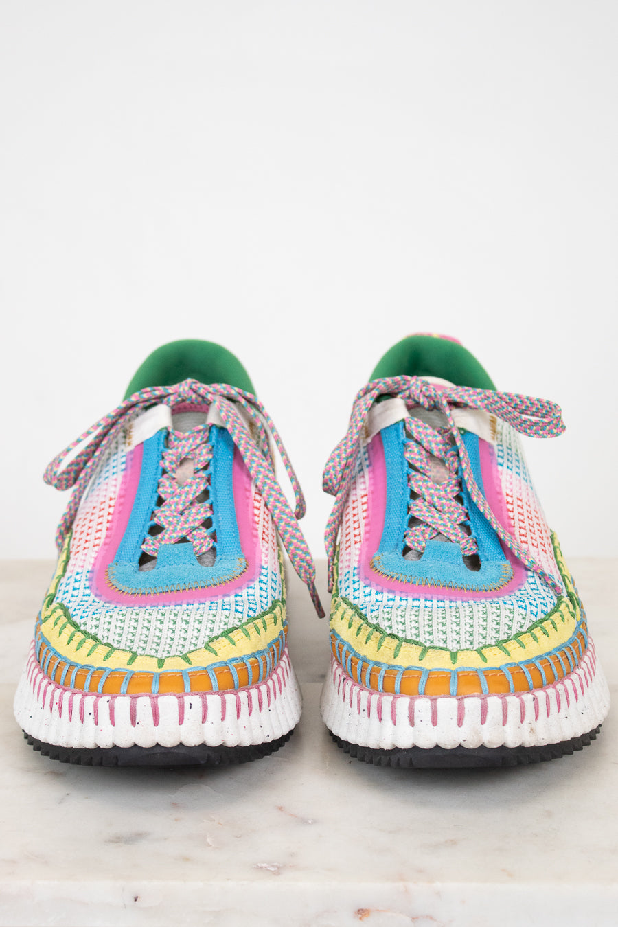 Colorful crochet sneakers on a white background