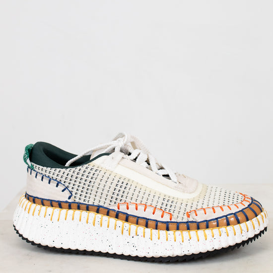 White sneaker with colorful sole on a white background