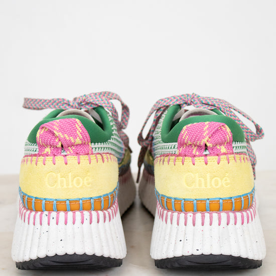 Colorful sneakers with a Chloe brand logo on back sitting on a light background