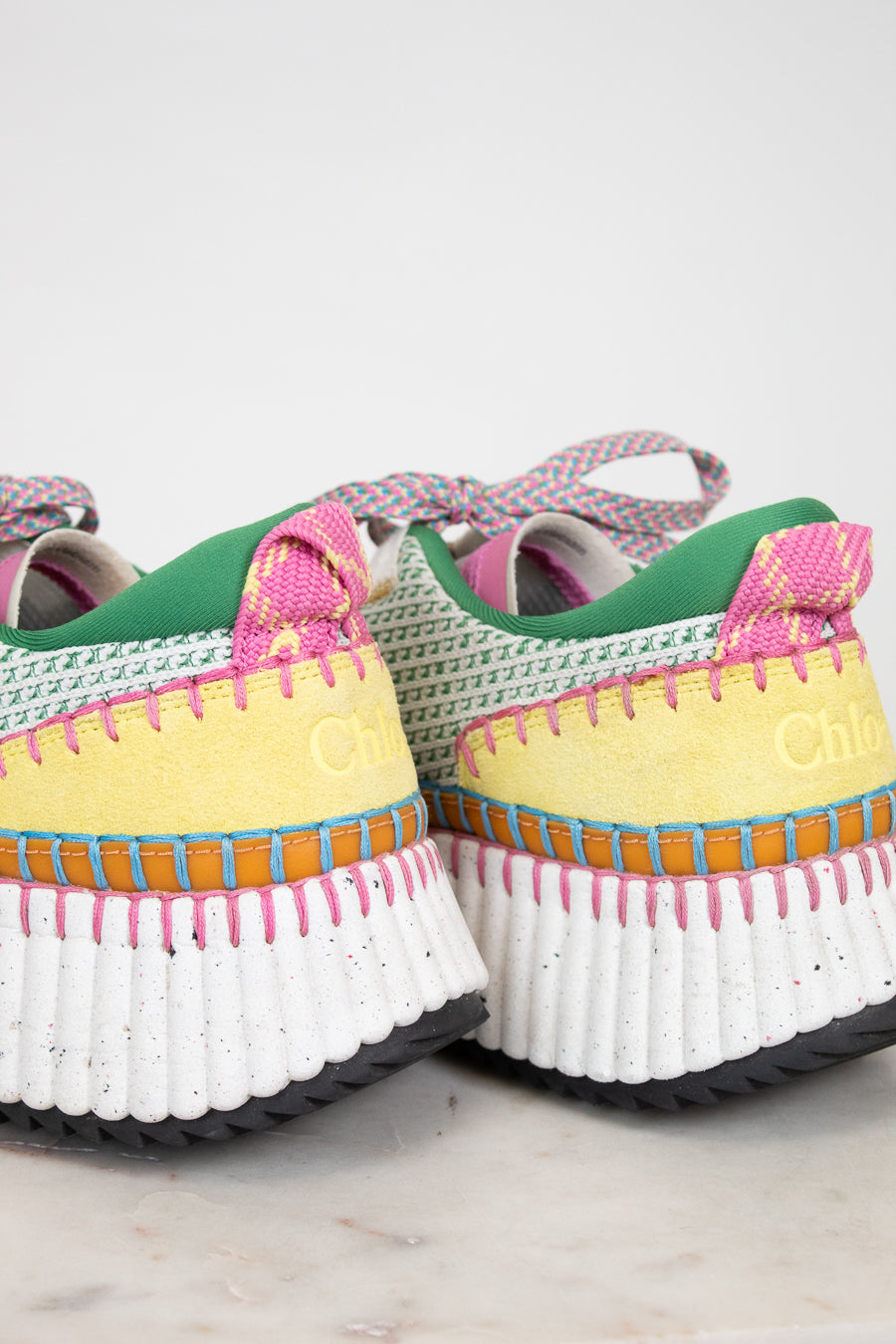 Colorful sneakers with white soles on a light background