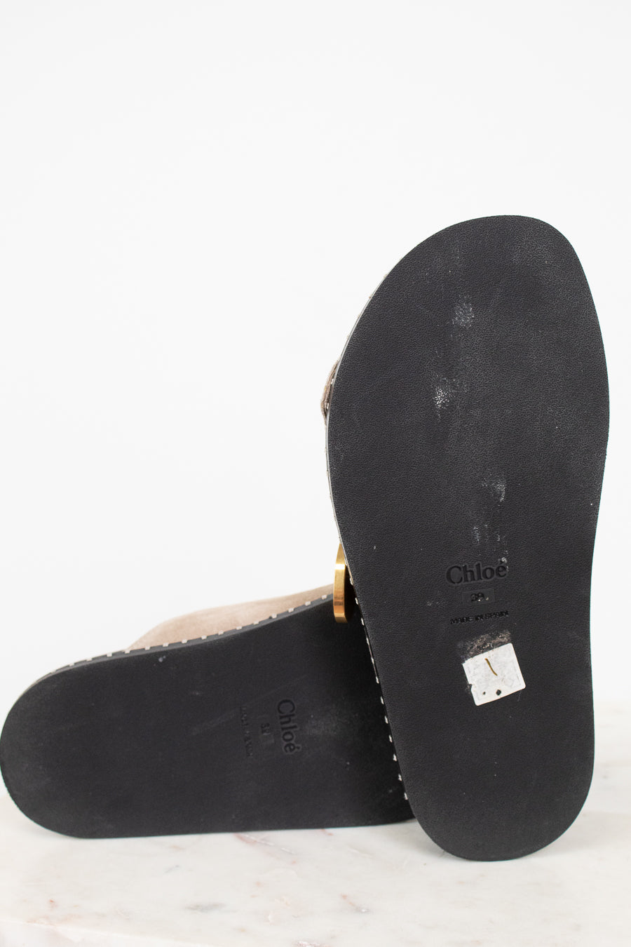 Black sole of a sandal with 'Chloe' branding on a white background