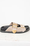 Beige sandal with gold buckle on a white background