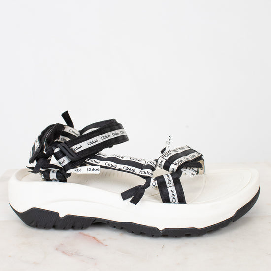 Side view of black and white 'Chloe' sandals