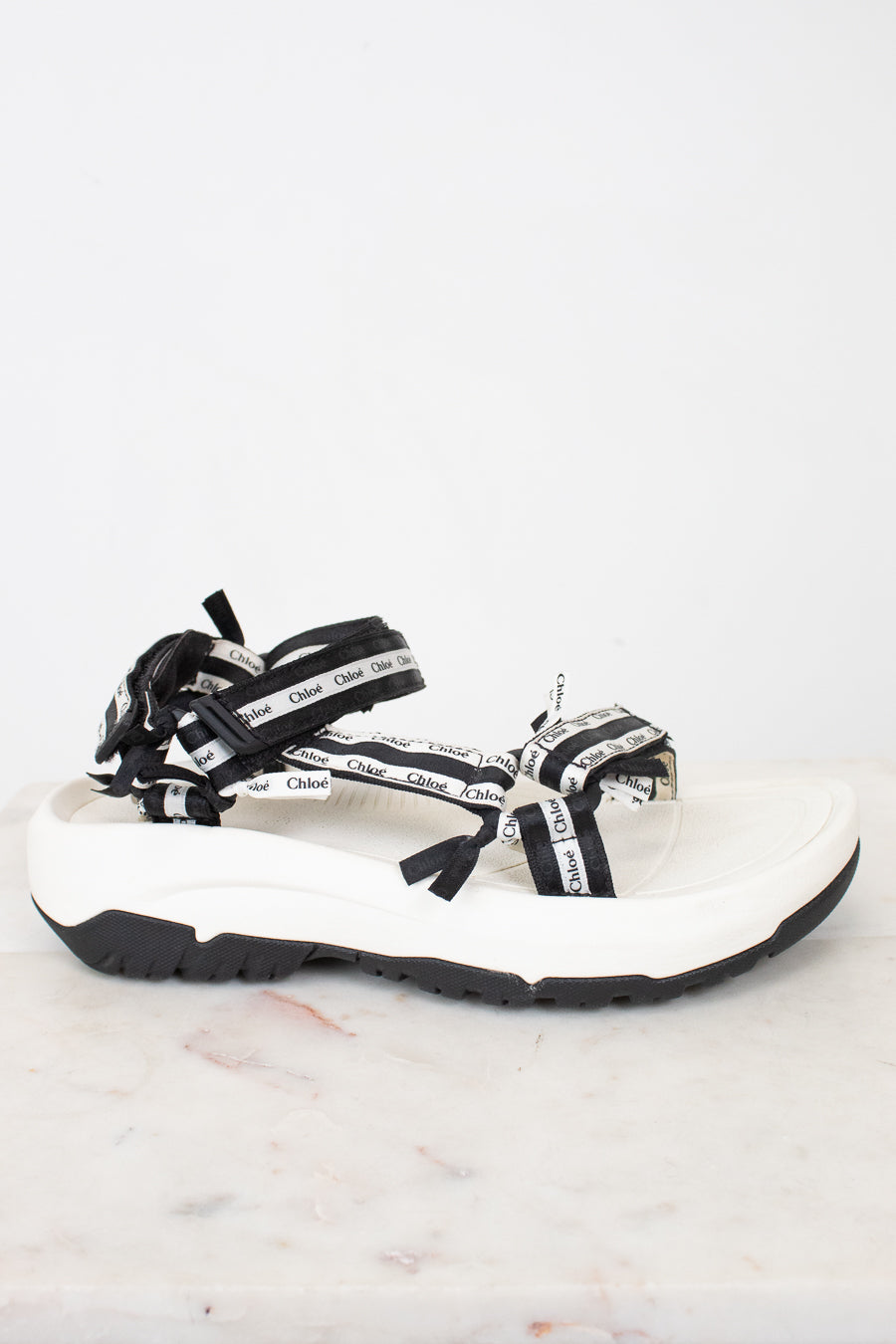 Side view of black and white 'Chloe' sandals