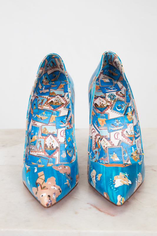 Pair of blue high-heeled shoes with colorful pattern on a white background