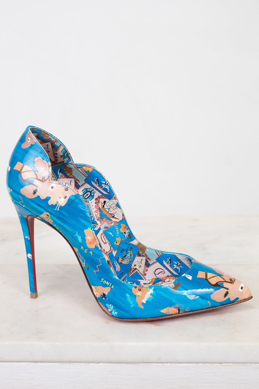 Blue high-heeled shoe with a colorful pattern on a white background