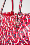 Red handbag with a colorful pattern and 'Louboutin' branding.