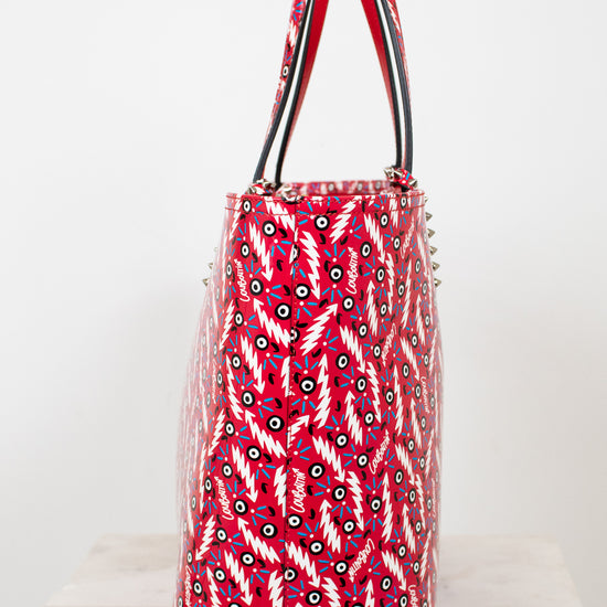 Red patterned handbag with silver studs on a white background