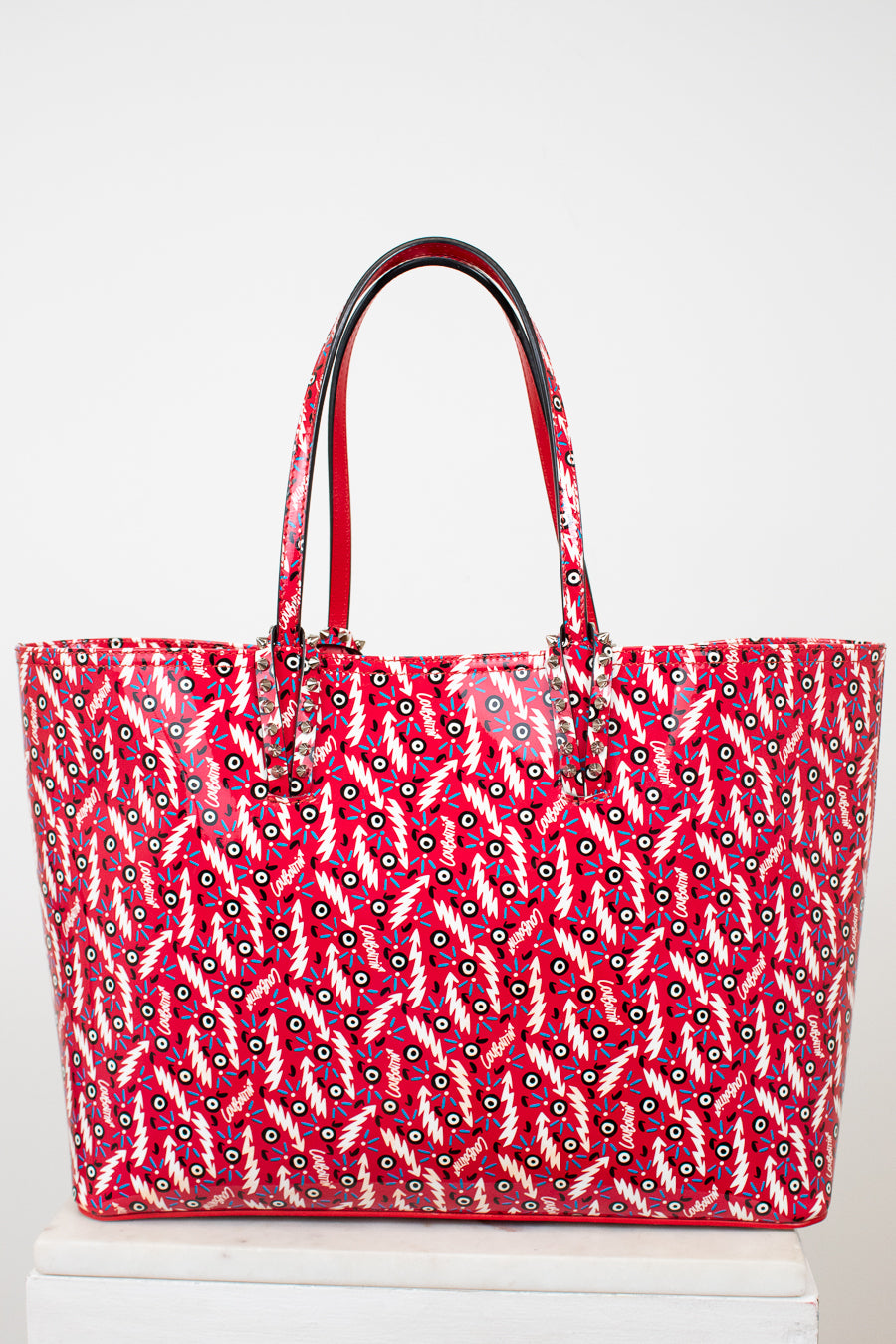 Red tote bag with white pattern on a white background