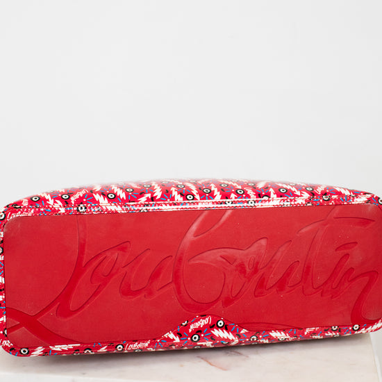 Red base of Louboutin tote with abstract pattern on a white background