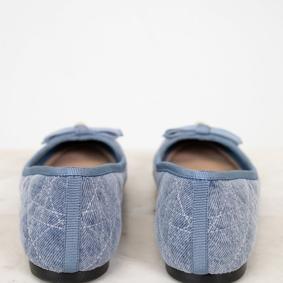 Pair of blue textured slippers on a light background