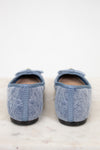 Pair of blue textured slippers on a light background