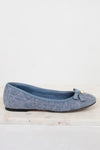Blue flat shoe with a bow on a light gray background