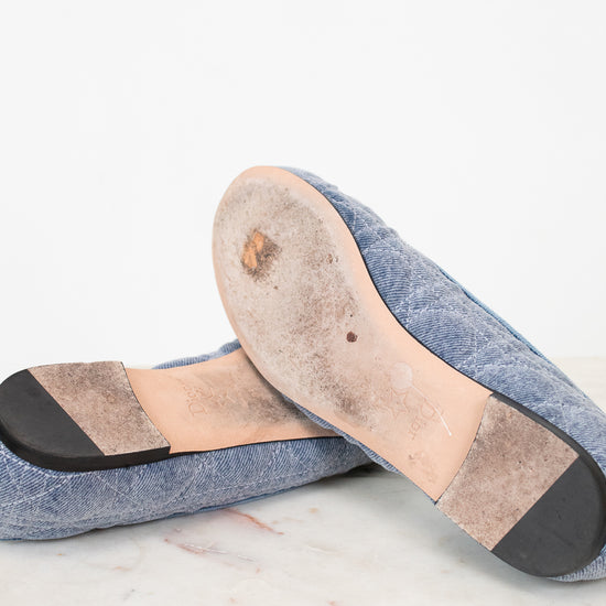 Close-up of a pair of blue slippers with a focus on the sole on a light background