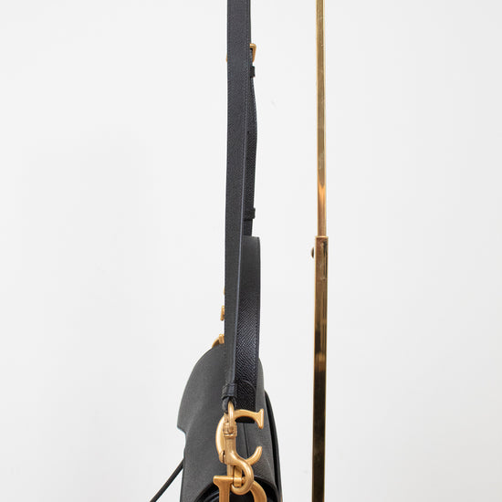Side view of black bag with 'CD' gold logo