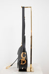 Side view of black bag with 'CD' gold logo