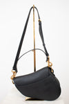 Back view of black bag with black straps on gold stand