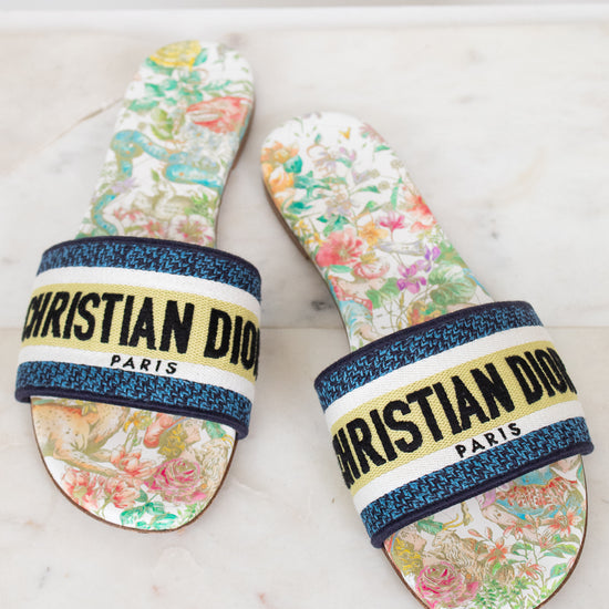 Floral sandals with 'Christian Dior' strap on a marble surface
