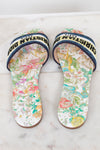 Floral sandals with 'Christian Dior' blue/black/white/chartreuse strap on a marble surface