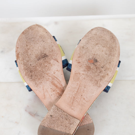 Bottom view of flat sandal soles with white and marble background