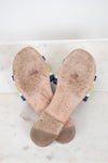 Bottom view of flat sandal soles with white and marble background