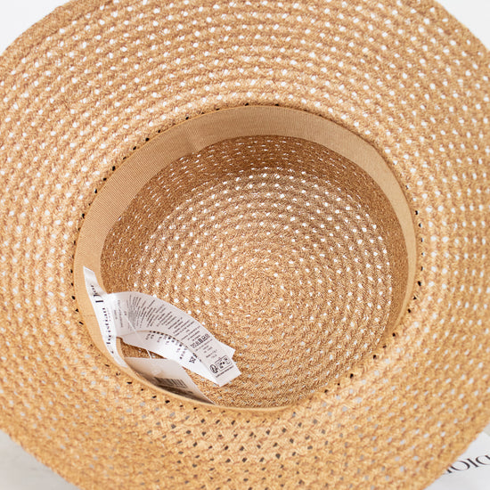 Woven straw hat with a visible brand label on a white background