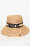 Beige straw hat with Christian Dior band on a white background