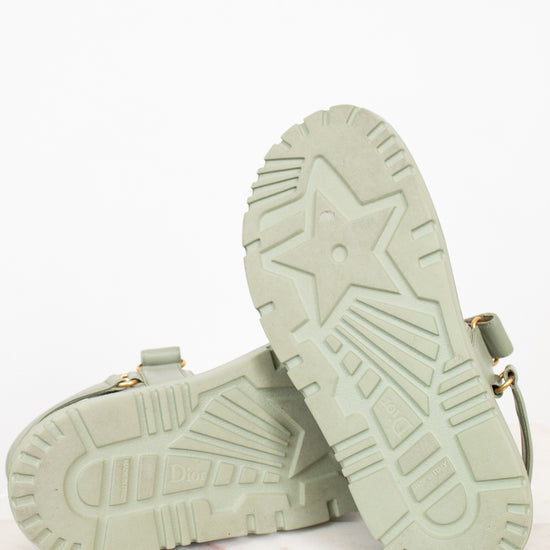 Pair of light green sandals on a white background