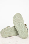 Pair of light green sandals on a white background