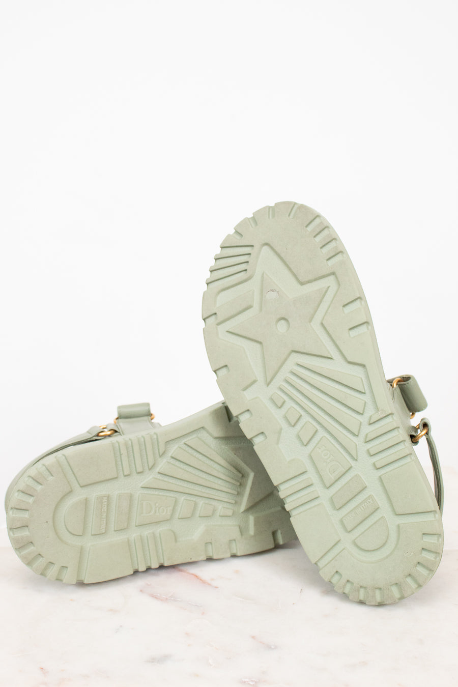 Pair of light green sandals on a white background