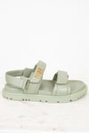 Green sandal with 'Dior' logo on a white background