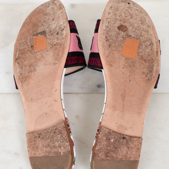 Bottom view of flat sandals with white marble background