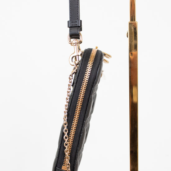 Black handbag with gold zipper and chain detail on a white background