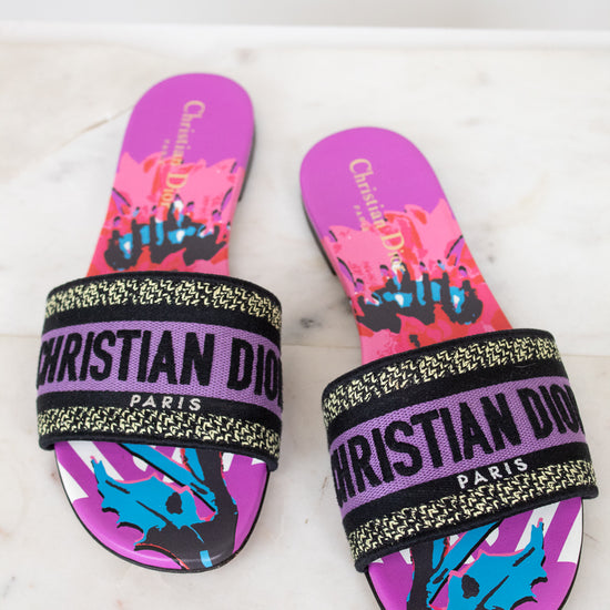 Pair of Christian Dior slides with colorful design on a white background