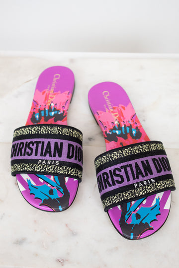 Pair of Christian Dior slides with colorful design on a white background