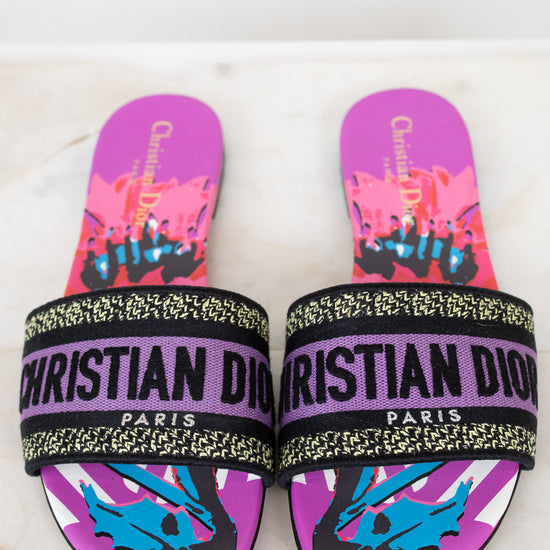 Purple Christian Dior slides with colorful design on a white and marble background
