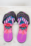 Pair of colorful sandals with 'Christian Dior' branding on a marble background