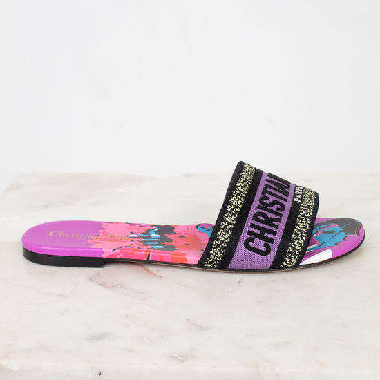 Colorful slide sandal with floral design on a white marble surface