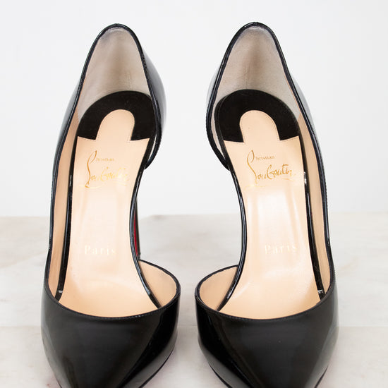 Pair of black high-heeled shoes on a light background