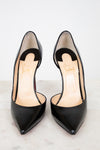 Pair of black high-heeled shoes on a light background