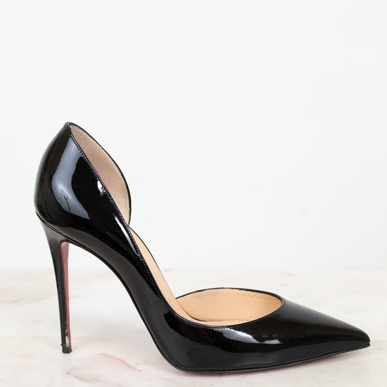 Black patent high-heeled shoe on a light background